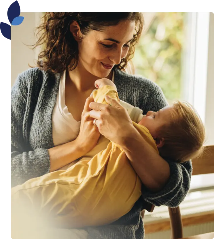 woman feeding a baby with a bottle